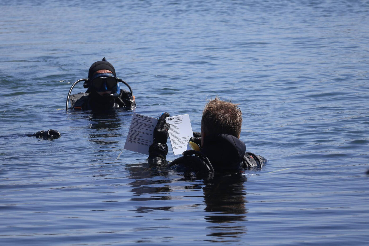 Jason briefing a diver at the surface with a dive slate